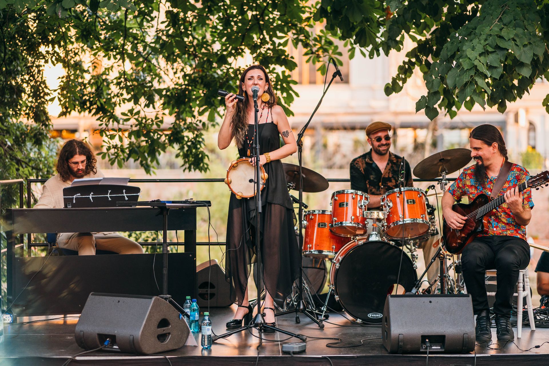 Mara Halunga performing outdoors with her band